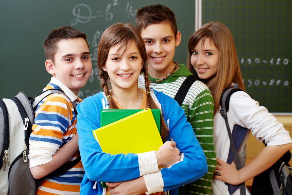 smiling students with backpacks